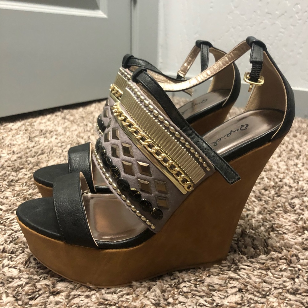 Woman’s black studded wedges